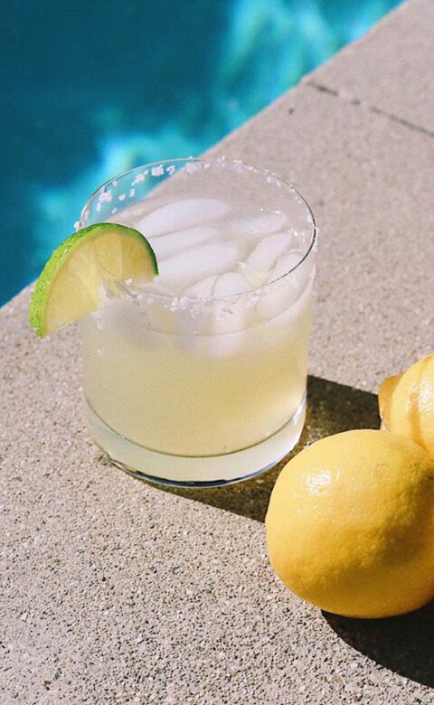 poolside cocktail and three lemons
